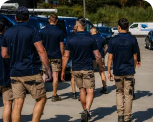 Plumbers walking to their service vans on a Cranebrook job